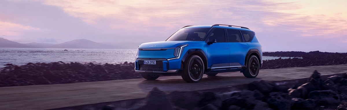 Blauer KIA EV9 vor Küstenhintergrund