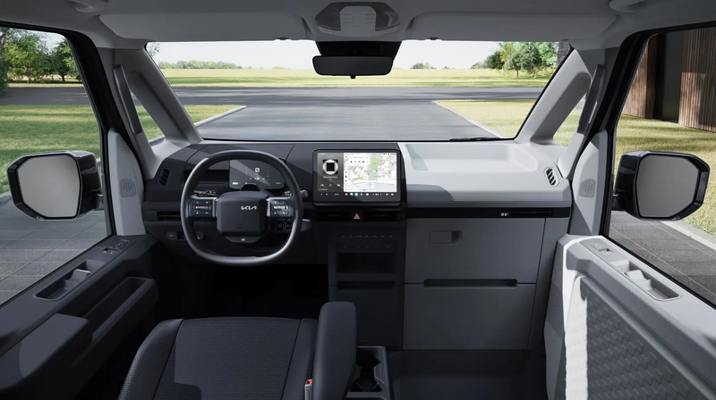 Kia PV5 Passenger – Ansicht in den Fahrerraum von hinten